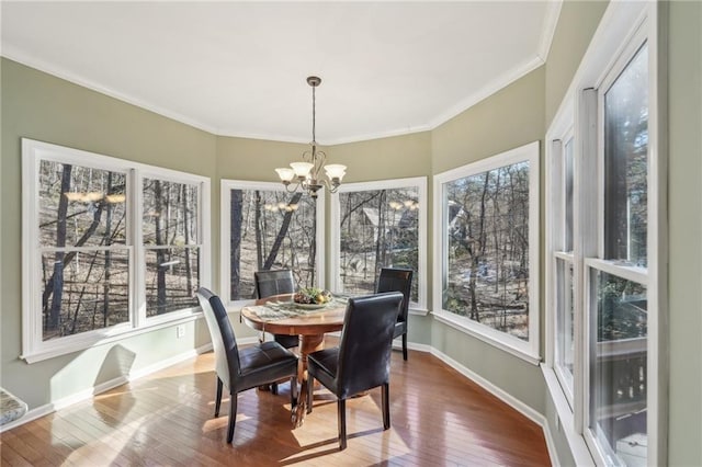 sunroom / solarium with a notable chandelier