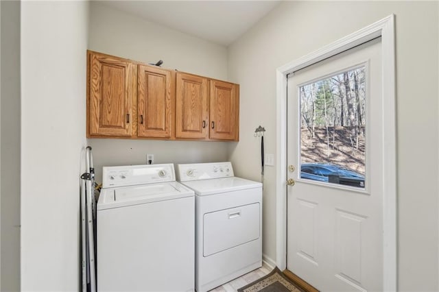 laundry room featuring washing machine and dryer and cabinets