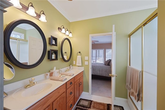 bathroom with a shower with door, tile patterned floors, vanity, and ornamental molding