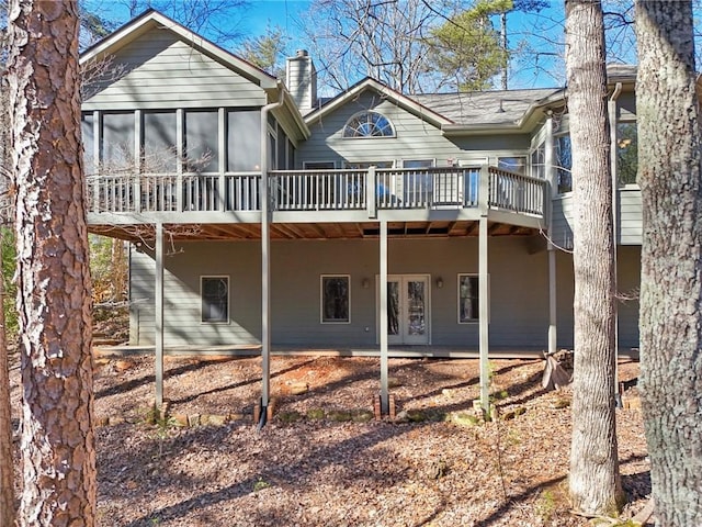 back of house featuring french doors and a deck