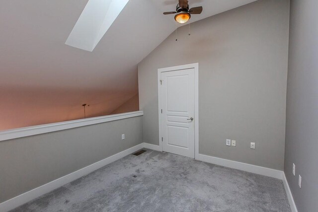 799 Hammond Dr Unit 406, Atlanta, GA 30328 - bonus room with carpet flooring, vaulted ceiling with skylight, baseboards, and a ceiling fan