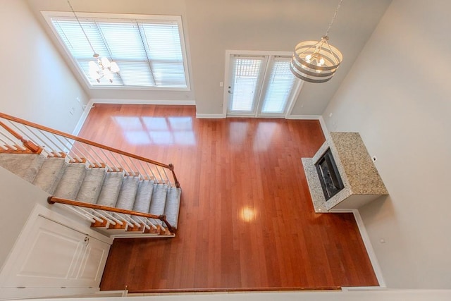 799 Hammond Dr Unit 406, Atlanta, GA 30328 - interior space with an inviting chandelier, wood finished floors, a fireplace, and baseboards