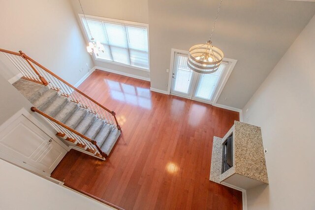 799 Hammond Dr Unit 406, Atlanta, GA 30328 - entrance foyer featuring baseboards, a notable chandelier, wood finished floors, and stairs