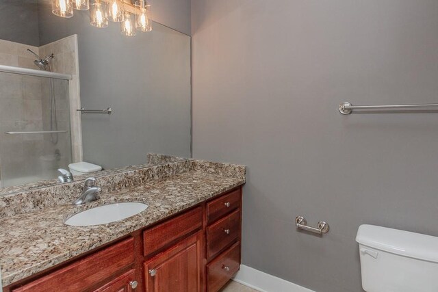 799 Hammond Dr Unit 406, Atlanta, GA 30328 - bathroom featuring vanity, toilet, baseboards, and a tile shower