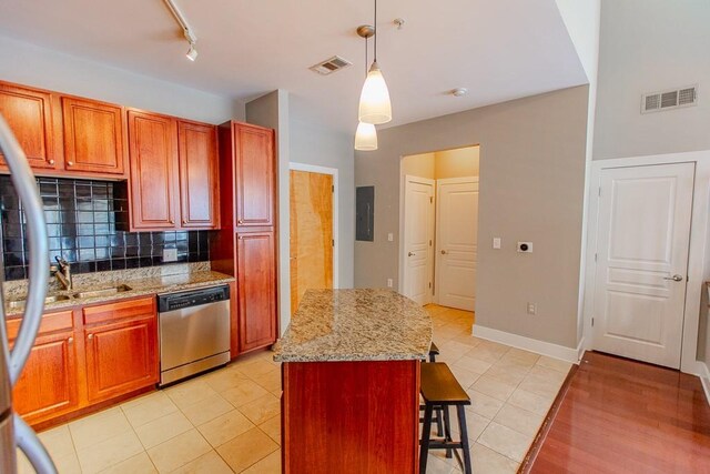 799 Hammond Dr Unit 406, Atlanta, GA 30328 - kitchen with decorative light fixtures, visible vents, tasteful backsplash, and stainless steel dishwasher