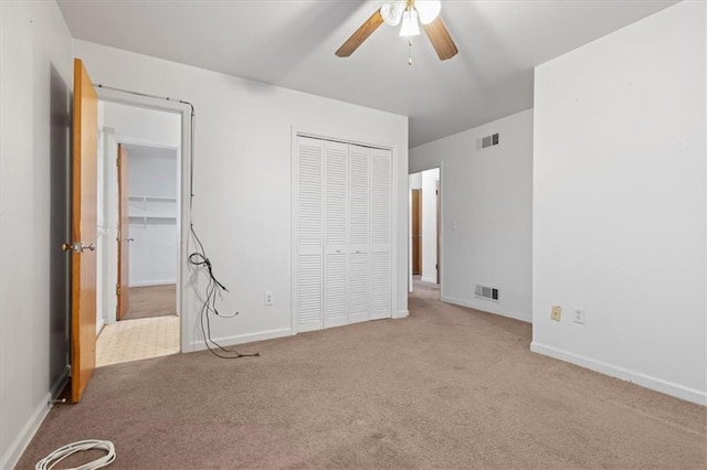 unfurnished bedroom with visible vents, carpet, baseboards, and a closet