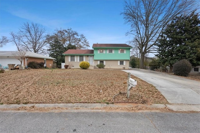 split level home featuring concrete driveway