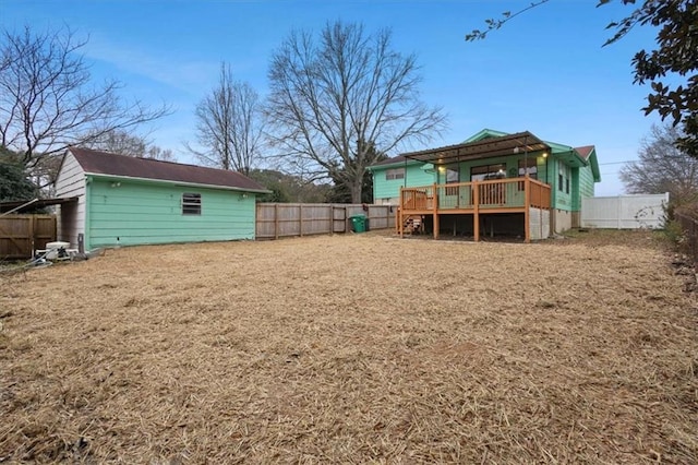 view of yard featuring a wooden deck and a fenced backyard