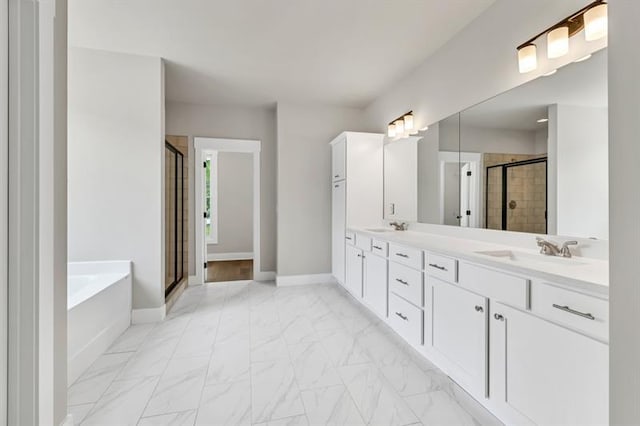231 E Marable St, Monroe, GA 30655 - full bath featuring a shower stall, a bath, double vanity, marble finish flooring, and baseboards