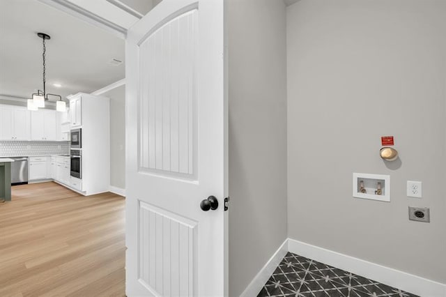 231 E Marable St, Monroe, GA 30655 - laundry room with hookup for an electric dryer, hookup for a washing machine, baseboards, and light wood-type flooring