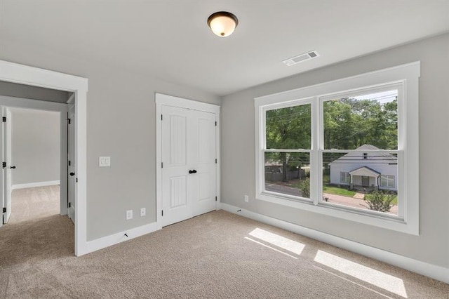 231 E Marable St, Monroe, GA 30655 - unfurnished bedroom featuring carpet floors, baseboards, and a closet