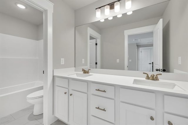 231 E Marable St, Monroe, GA 30655 - bathroom featuring double vanity, toilet, marble look tile flooring, and tub / shower combination