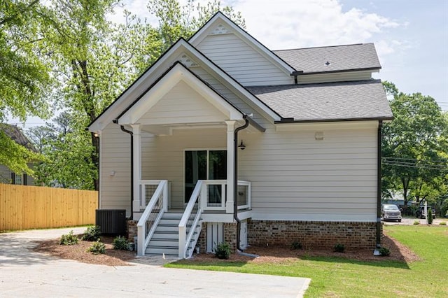 231 E Marable St, Monroe, GA 30655 - view of front facade featuring central AC and roof with shingles
