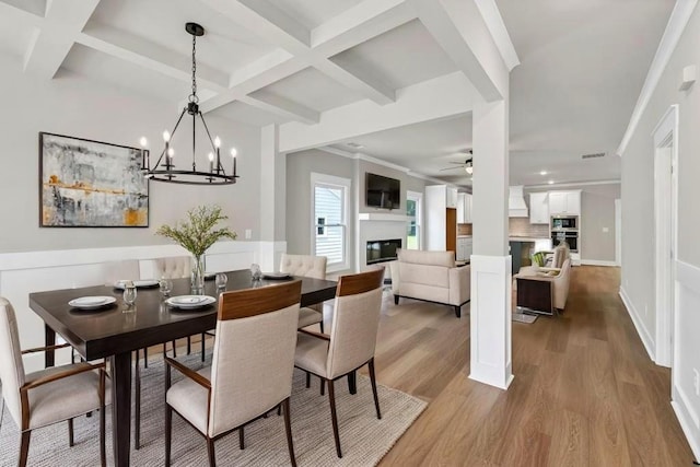 231 E Marable St, Monroe, GA 30655 - dining area with coffered ceiling, ceiling fan, wood finished floors, beam ceiling, and a chandelier