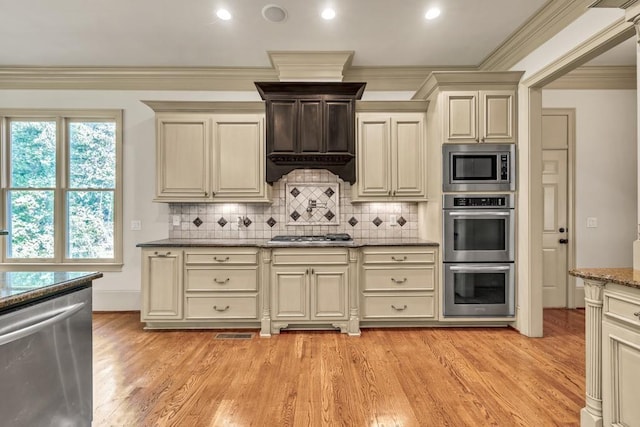 9145 Greenway Ct, Gainesville, GA 30506 - kitchen featuring stainless steel appliances, crown molding, light wood finished floors, stone countertops, and backsplash