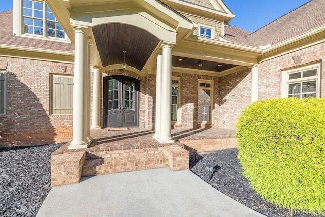 9145 Greenway Ct, Gainesville, GA 30506 - doorway to property with covered porch, brick siding, and a shingled roof
