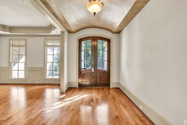 9145 Greenway Ct, Gainesville, GA 30506 - entrance foyer with wood finished floors, french doors, vaulted ceiling, wainscoting, and arched walkways