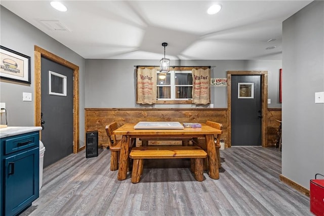 dining area with wainscoting, wood finished floors, visible vents, and recessed lighting