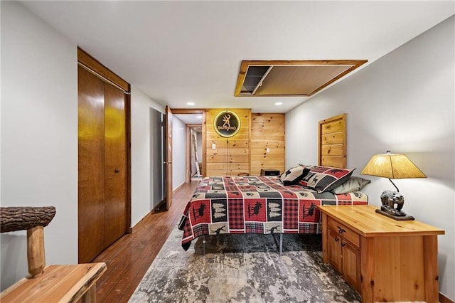 bedroom with dark wood finished floors and recessed lighting