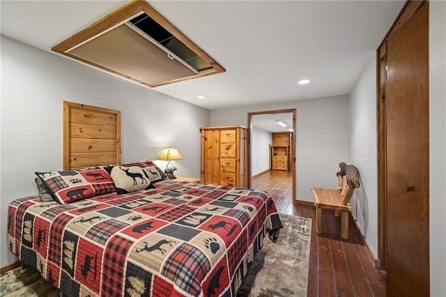 bedroom with attic access, wood finished floors, and recessed lighting