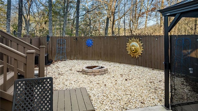 view of yard with an outdoor fire pit and a fenced backyard