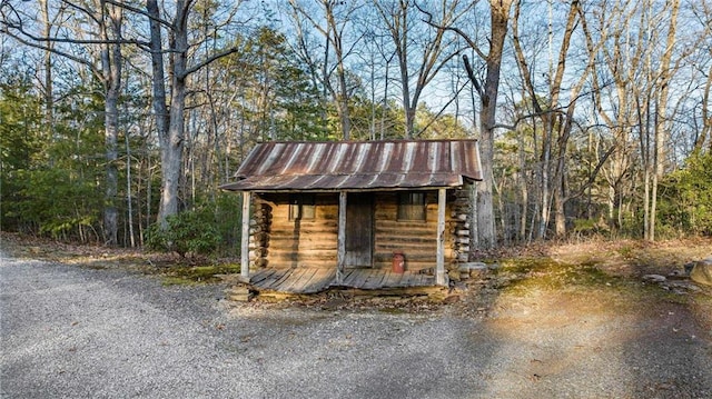 view of outdoor structure featuring a forest view and an outdoor structure