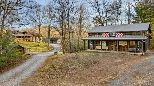 exterior space featuring metal roof and driveway