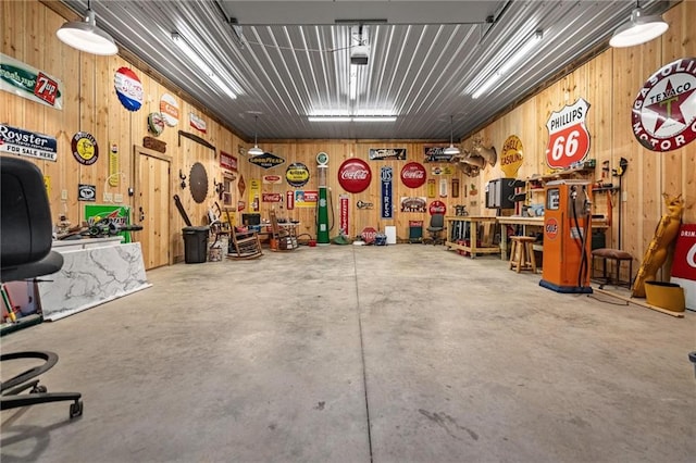 garage with wood walls and a workshop area