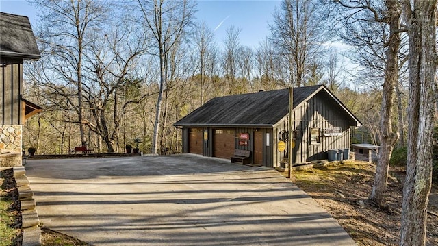 view of front of house featuring a garage, central AC, and board and batten siding