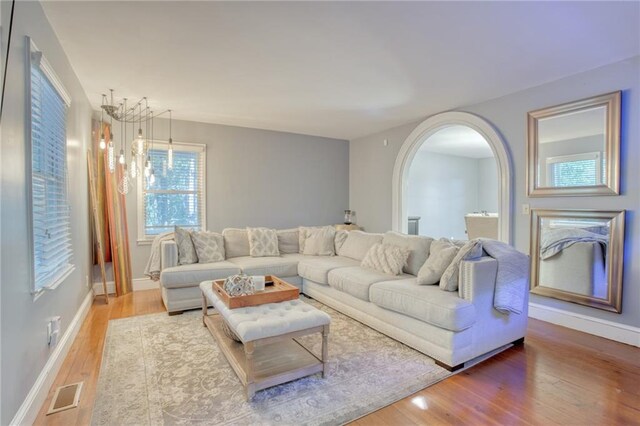 living room featuring a notable chandelier and hardwood / wood-style flooring