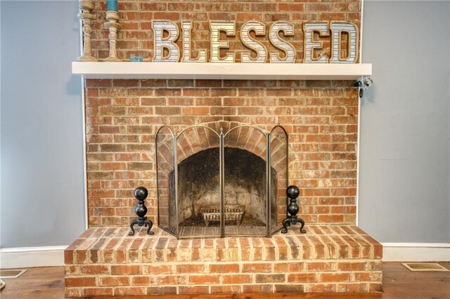 details featuring a fireplace and hardwood / wood-style flooring