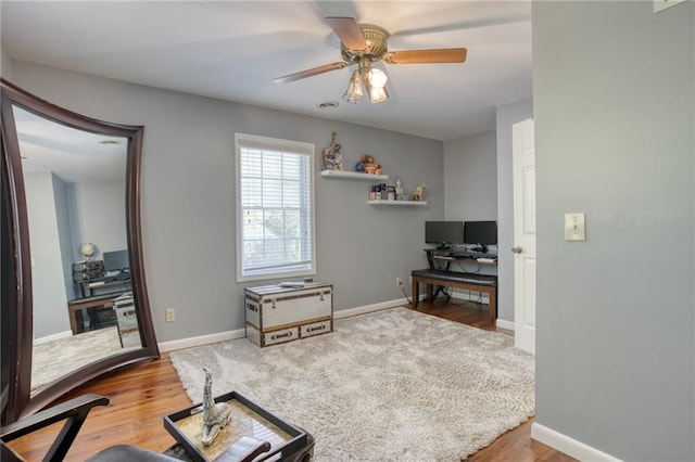 home office featuring wood-type flooring and ceiling fan