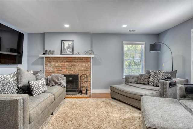 living room with a fireplace and hardwood / wood-style floors