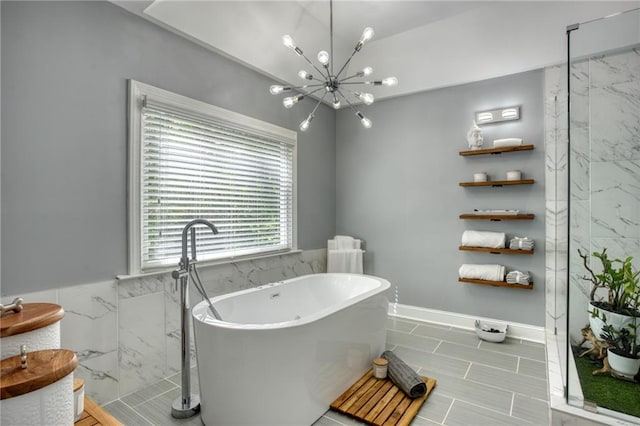 bathroom featuring separate shower and tub and an inviting chandelier