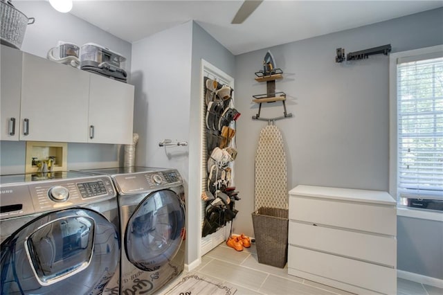 laundry area featuring washer and dryer and cabinets