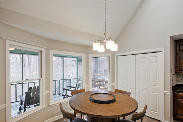 dining area featuring an inviting chandelier and lofted ceiling