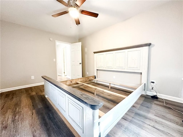 unfurnished bedroom with ceiling fan, baseboards, and dark wood-style flooring