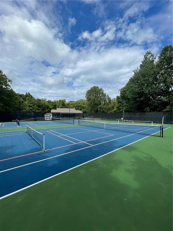 view of tennis court featuring fence