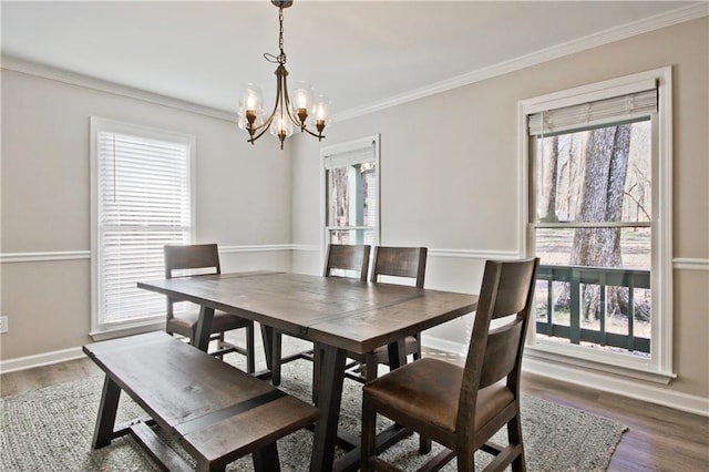 dining space featuring plenty of natural light, wood finished floors, and ornamental molding