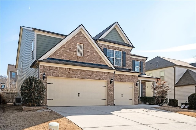 view of front of house featuring a garage and central AC