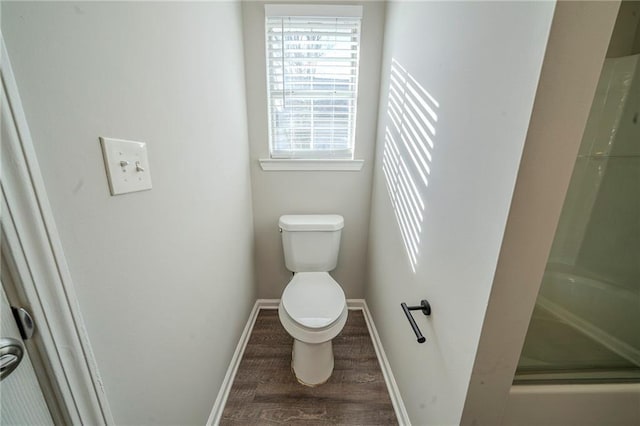 bathroom featuring hardwood / wood-style flooring, toilet, and walk in shower