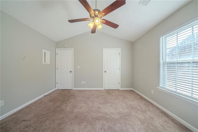 interior space featuring light carpet, vaulted ceiling, and ceiling fan