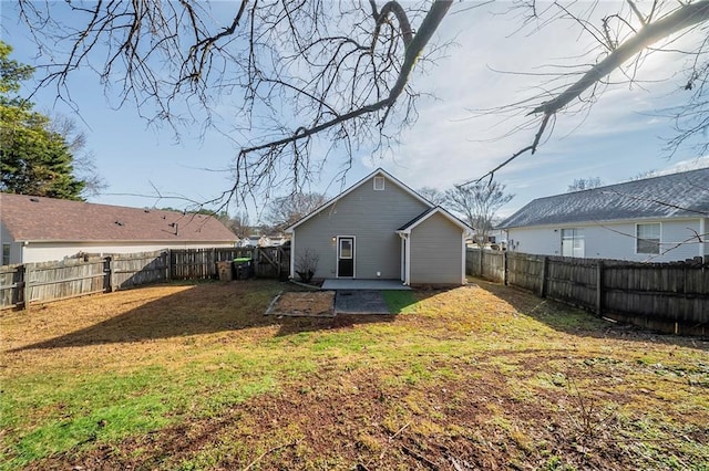 back of house featuring a yard and a patio area