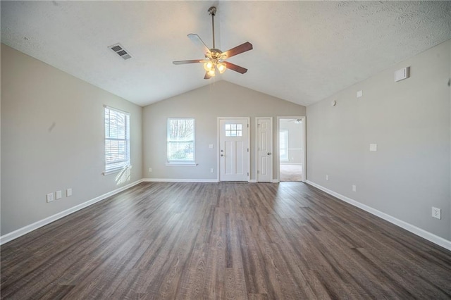 unfurnished living room featuring ceiling fan, dark hardwood / wood-style flooring, and vaulted ceiling