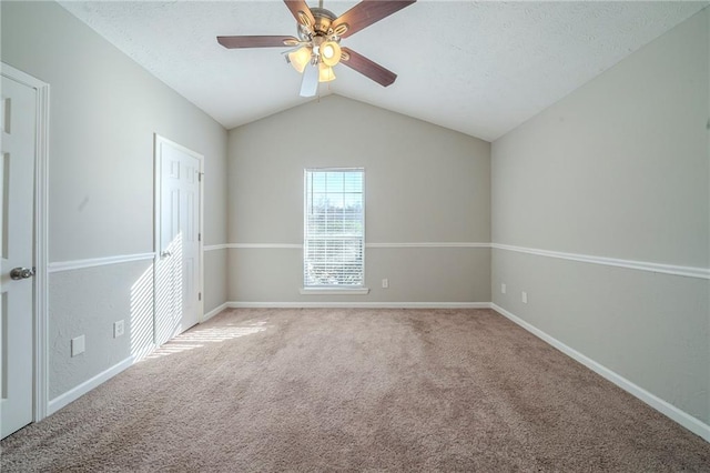 unfurnished bedroom with ceiling fan, lofted ceiling, carpet, and a textured ceiling