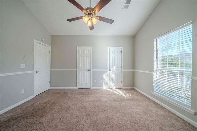 unfurnished room featuring ceiling fan, light colored carpet, and vaulted ceiling