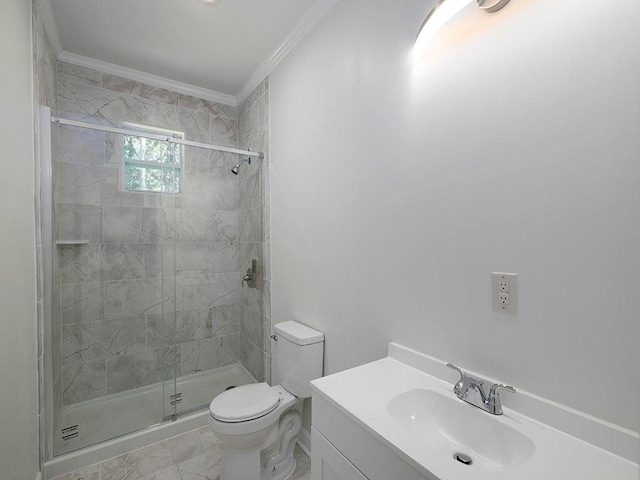 bathroom with vanity, toilet, ornamental molding, and a shower with door