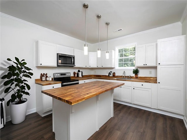 kitchen featuring white cabinetry, pendant lighting, wooden counters, and black range with electric cooktop