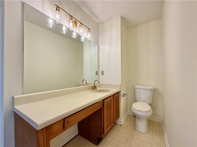 bathroom with tile patterned flooring, vanity, toilet, and baseboards