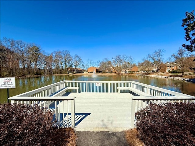 dock area featuring a deck with water view